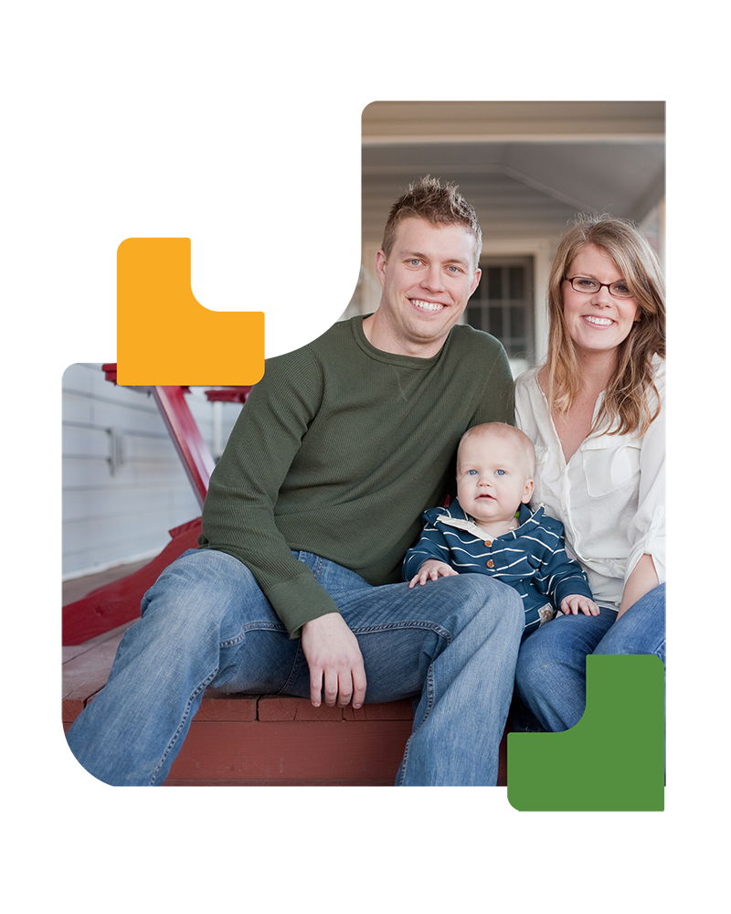 Young family sitting on porch with their baby