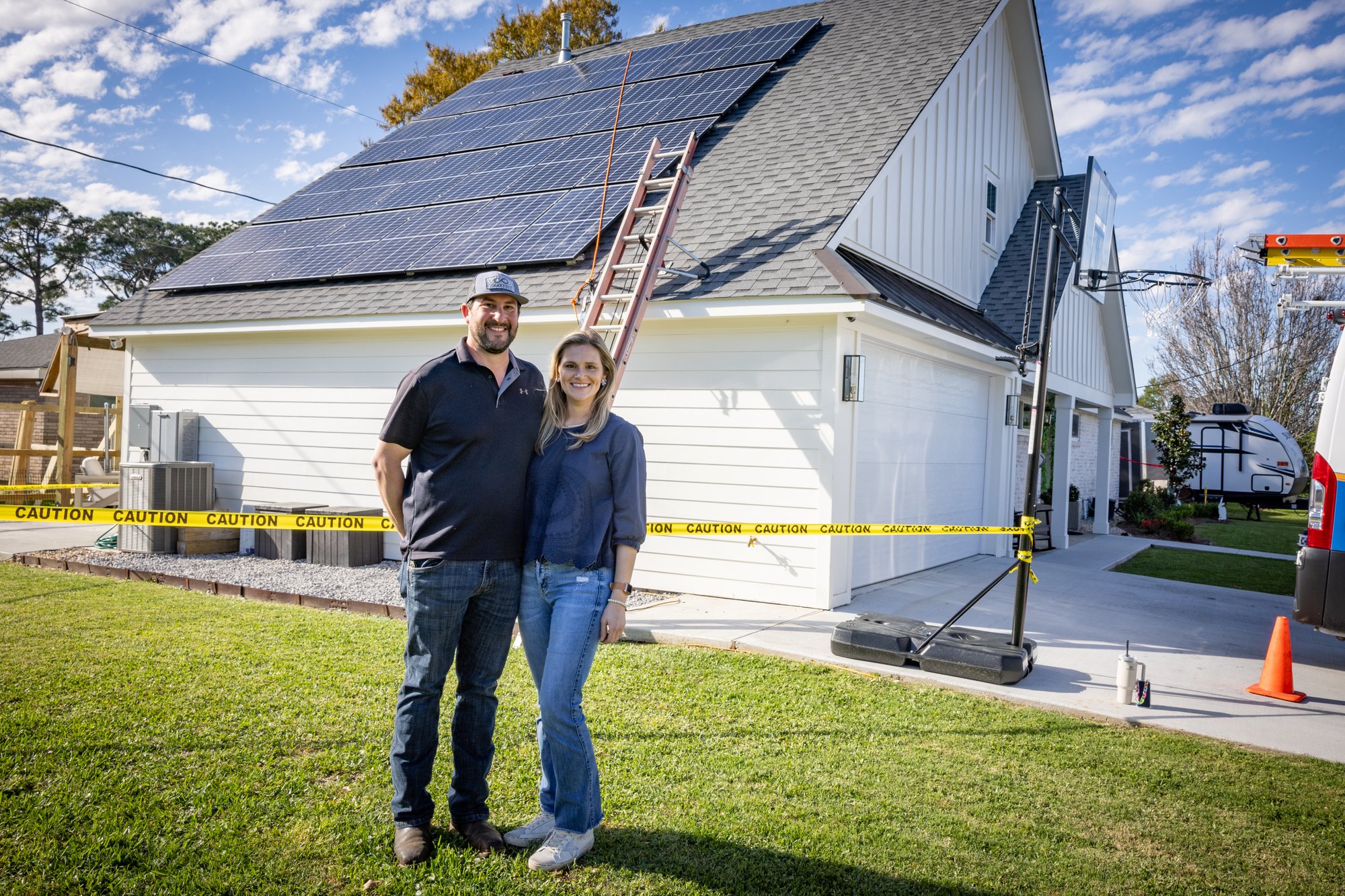 Family outside of house with solar panels