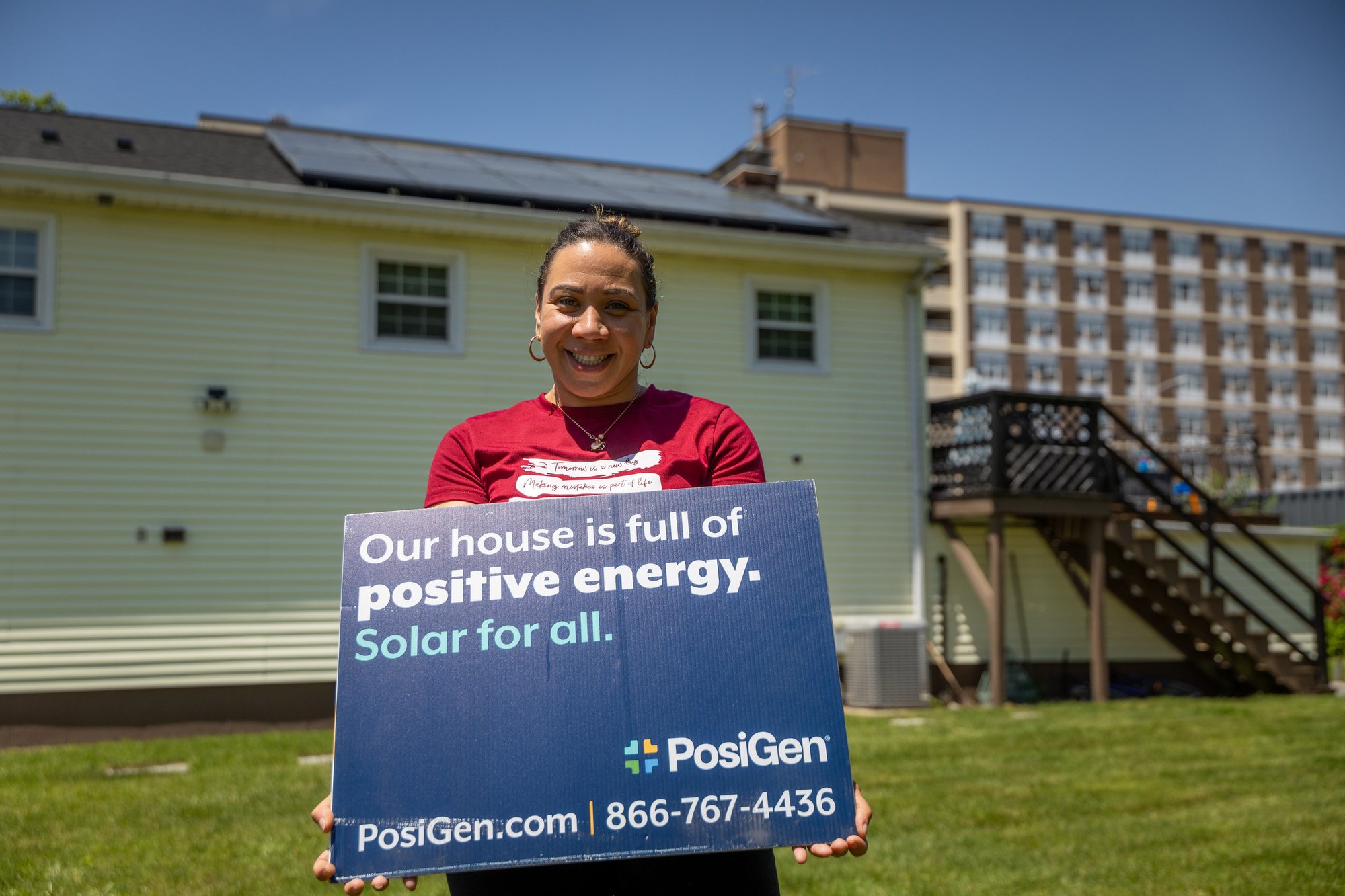 Lady outside of house with solar panels